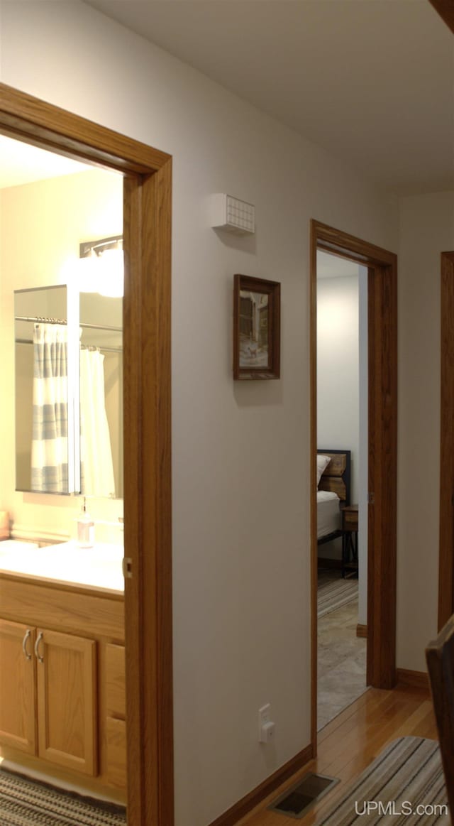 corridor featuring light hardwood / wood-style floors