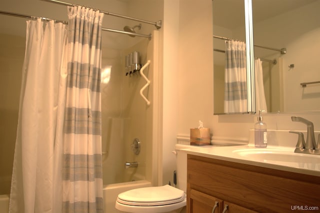 full bathroom with vanity, shower / bathtub combination with curtain, and toilet