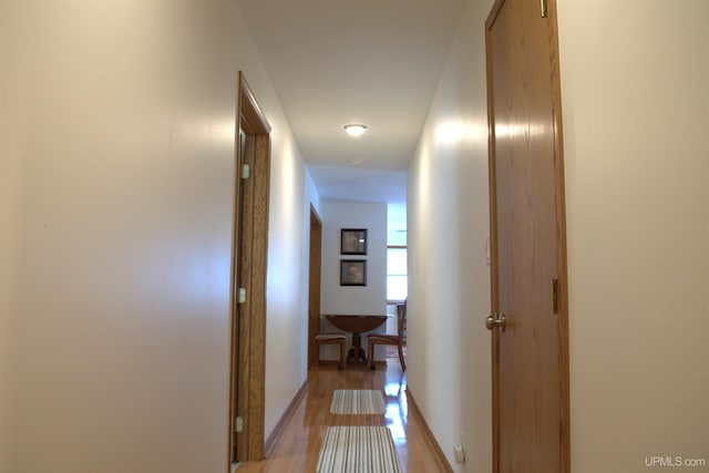 corridor with light wood-type flooring