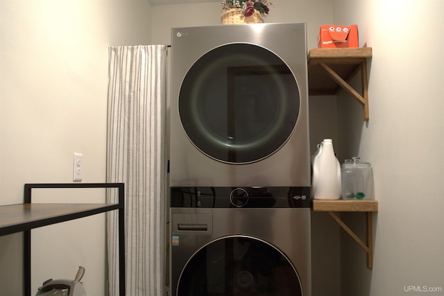 washroom featuring stacked washer / dryer