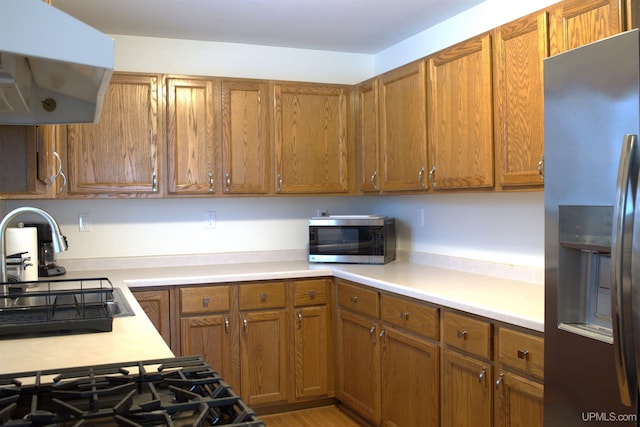 kitchen featuring appliances with stainless steel finishes, sink, and extractor fan