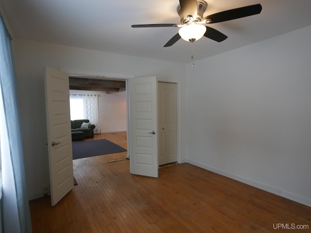 interior space with hardwood / wood-style floors and ceiling fan