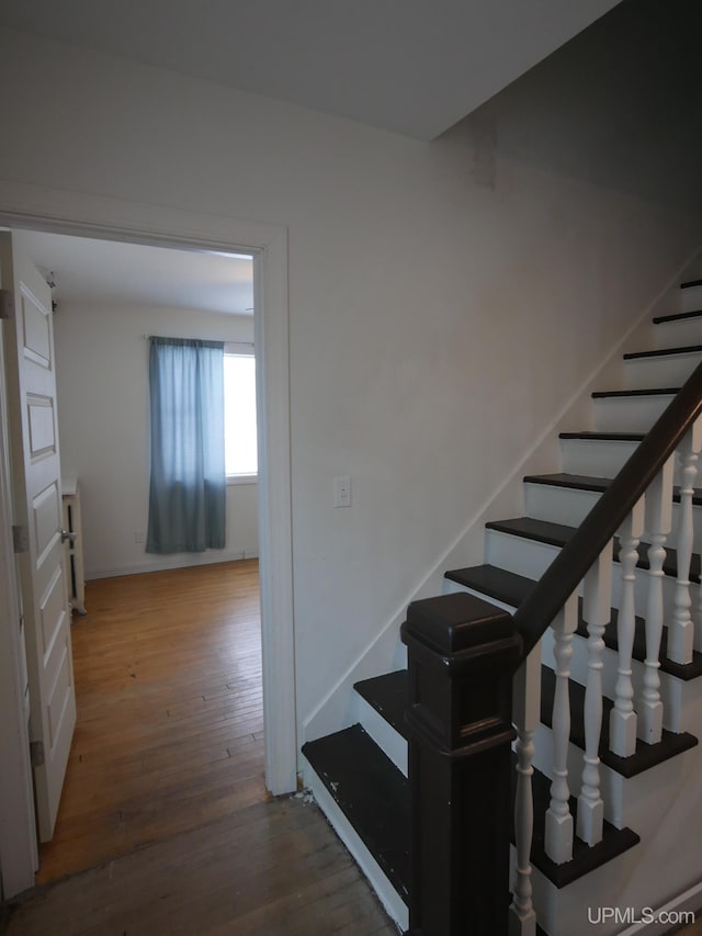 stairway featuring hardwood / wood-style flooring