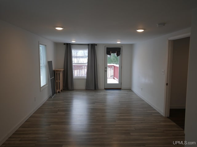 spare room featuring dark wood-type flooring