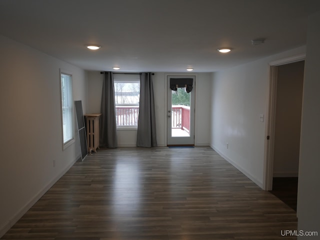 unfurnished room featuring dark wood-type flooring