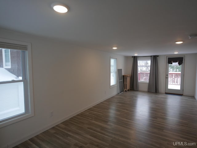 spare room featuring dark wood-type flooring