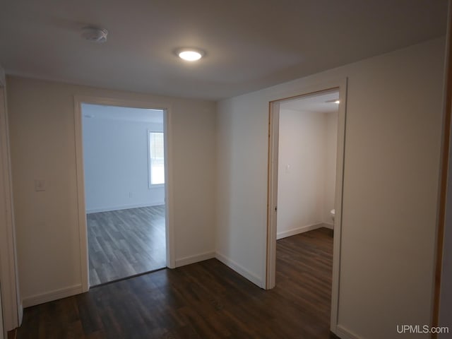 unfurnished room with dark hardwood / wood-style floors