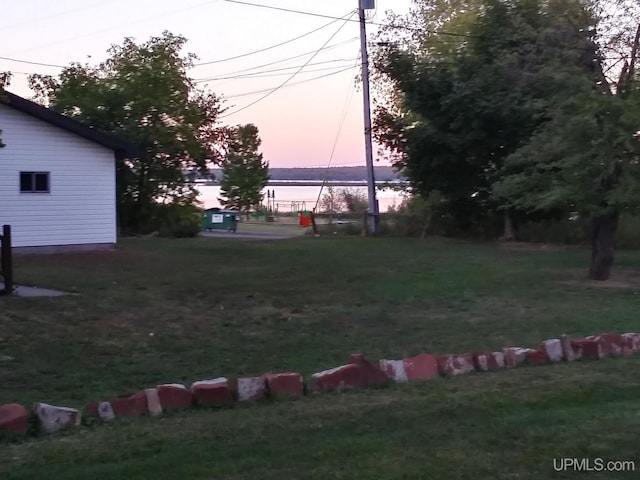 yard at dusk with a water view