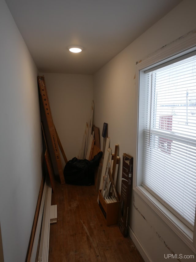 hallway with dark hardwood / wood-style floors