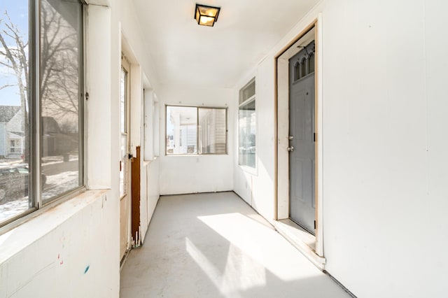 unfurnished sunroom featuring a wealth of natural light