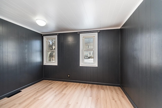 spare room with light hardwood / wood-style flooring