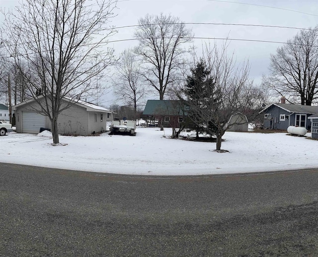 yard covered in snow with a garage