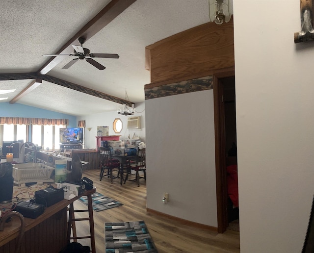 living room with lofted ceiling with beams, ceiling fan, hardwood / wood-style flooring, and a textured ceiling