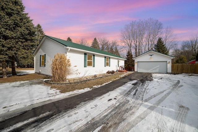 single story home featuring an outbuilding and a garage