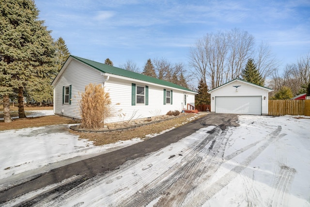 ranch-style home with an outbuilding and a garage