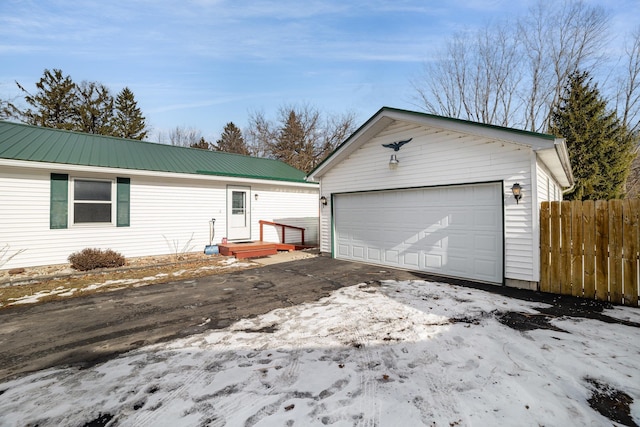 single story home featuring an outbuilding and a garage