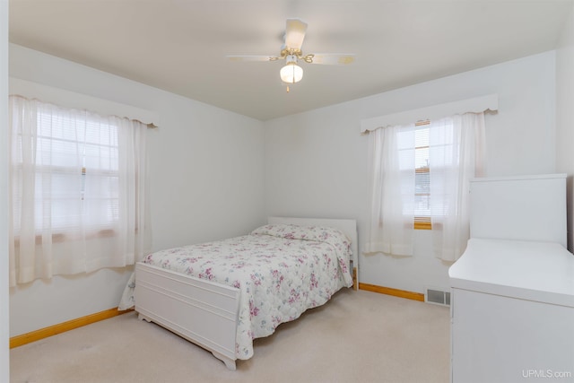 bedroom featuring ceiling fan and light carpet