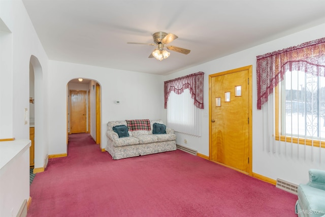 living area featuring ceiling fan and carpet