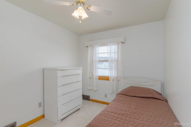 bedroom featuring light colored carpet and ceiling fan