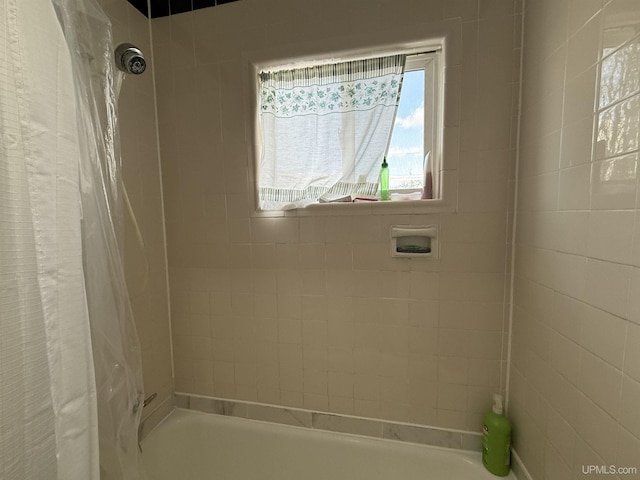 bathroom with shower / bath combo with shower curtain