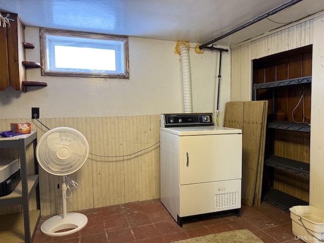 laundry area with washer / clothes dryer and dark tile patterned floors