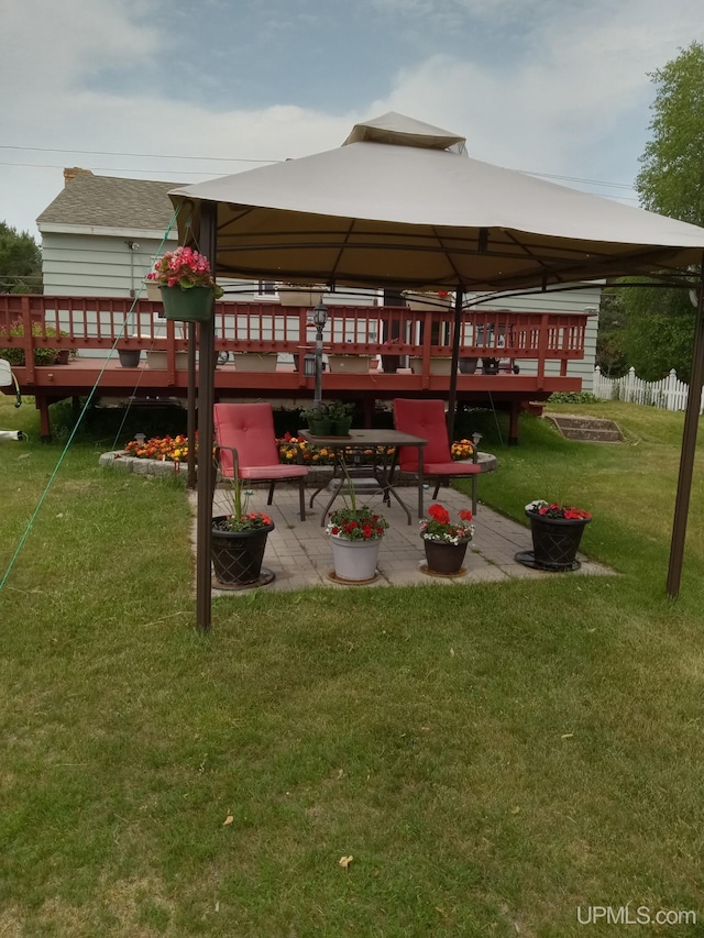 view of community with a gazebo, a patio, a deck, and a lawn