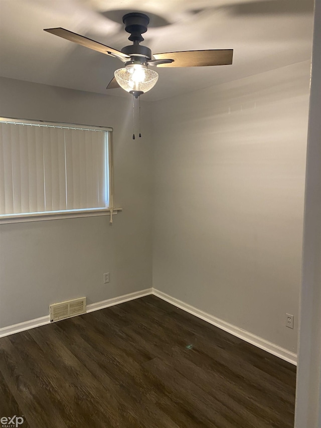 empty room with ceiling fan and dark hardwood / wood-style flooring