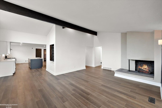 unfurnished living room with lofted ceiling with beams and dark hardwood / wood-style floors