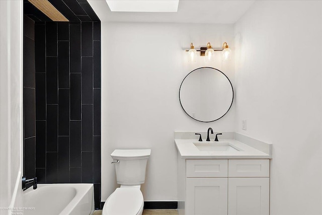 full bathroom with vanity, tiled shower / bath, and toilet