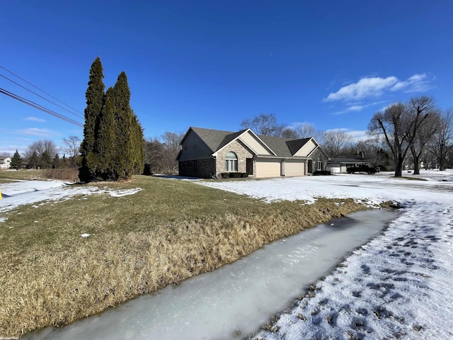 view of front of house featuring a garage and a yard