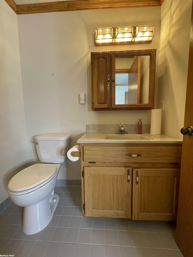 bathroom featuring vanity, tile patterned floors, and toilet