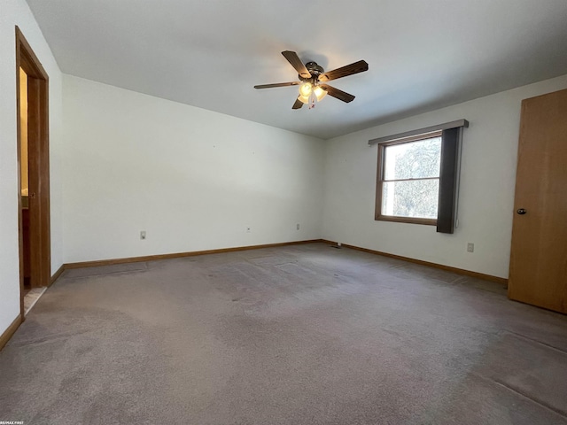 spare room featuring ceiling fan and carpet