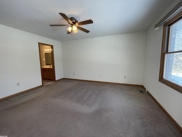 spare room with ceiling fan and carpet