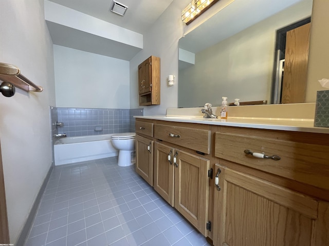 bathroom featuring tile patterned flooring, vanity, a bath, and toilet