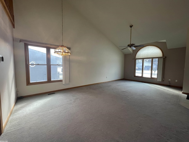 interior space with carpet floors, ceiling fan with notable chandelier, and high vaulted ceiling