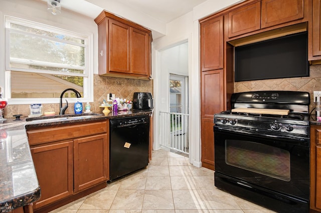 kitchen featuring tasteful backsplash, light tile patterned flooring, sink, and black appliances