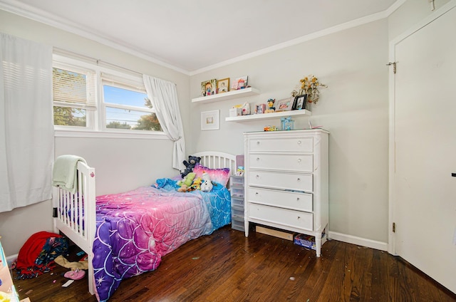 bedroom with ornamental molding and dark hardwood / wood-style flooring