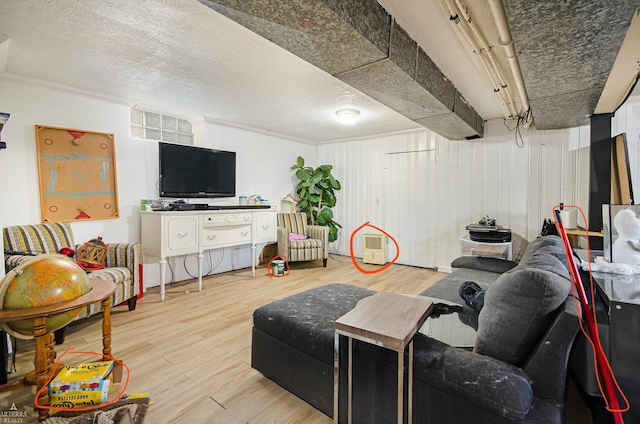 living room with wood-type flooring and a textured ceiling