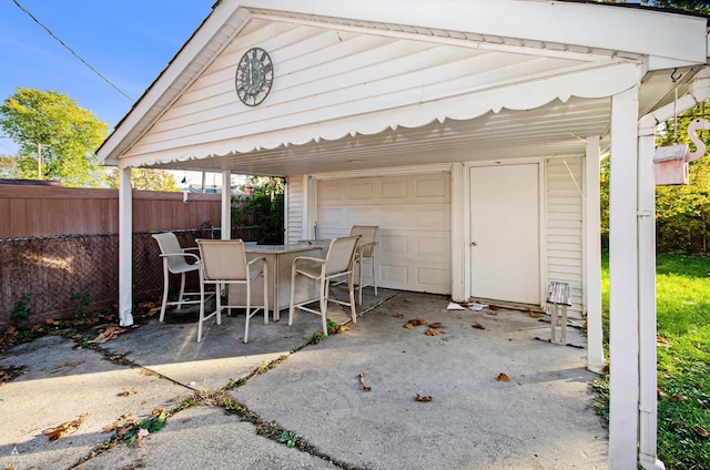 view of patio / terrace with a bar and a garage