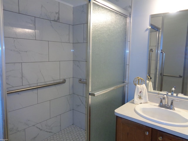 bathroom featuring walk in shower and vanity