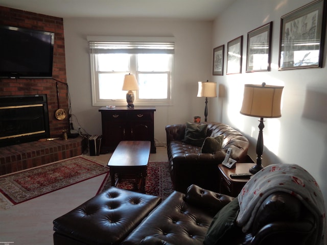 living room with a brick fireplace