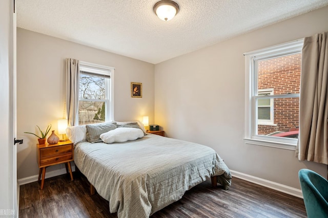 bedroom featuring dark hardwood / wood-style floors and a textured ceiling