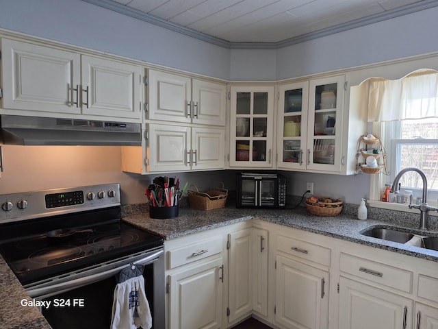 kitchen with electric stove, ornamental molding, sink, and white cabinets