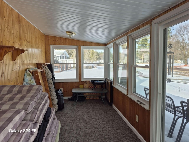 sunroom / solarium featuring vaulted ceiling and plenty of natural light