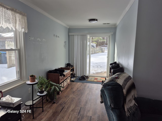 living room featuring ornamental molding and dark hardwood / wood-style floors