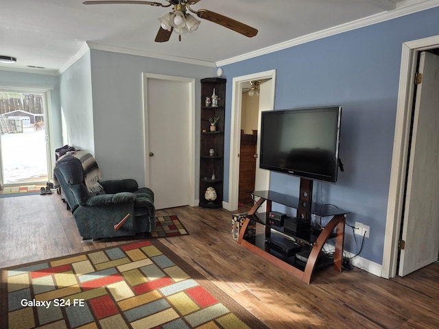 living room with crown molding, dark wood-type flooring, and ceiling fan