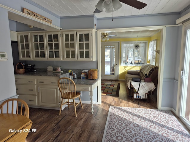 kitchen featuring dark wood-type flooring, wood ceiling, dark stone countertops, ornamental molding, and ceiling fan