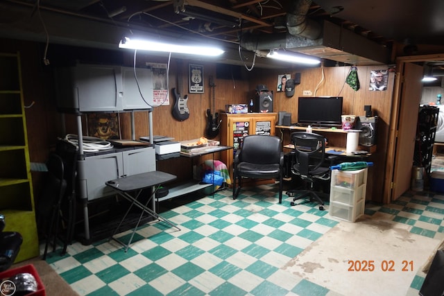 home office with wood walls and tile patterned floors