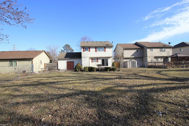 back of house with a lawn