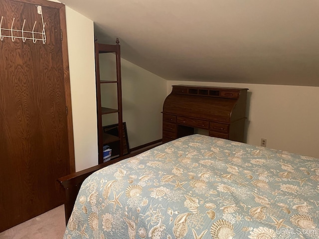 carpeted bedroom featuring vaulted ceiling